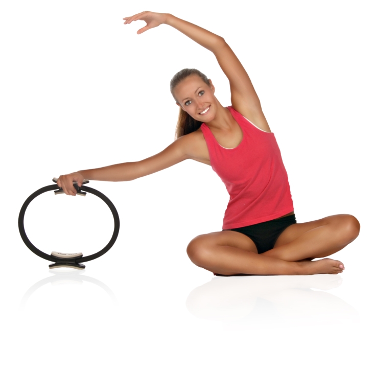 Woman seat bent her body side with Aeropilates Magic Circle