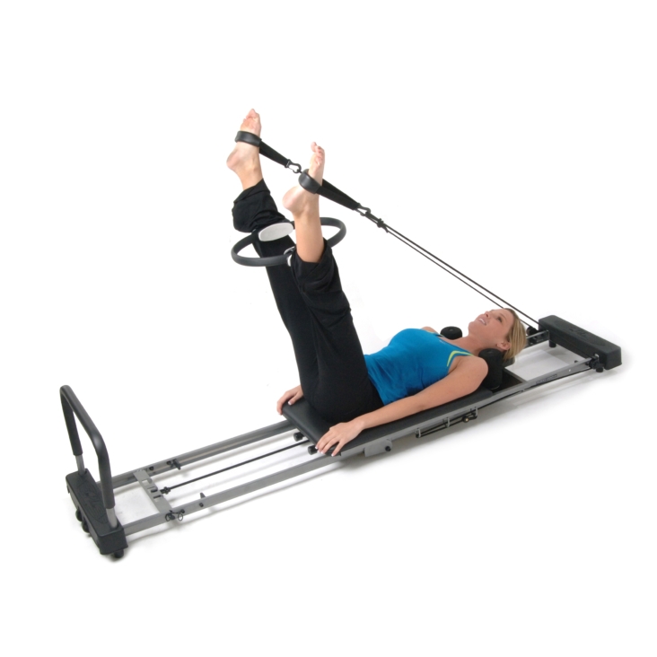 Woman workout on AeroPilates Magic Circle with DVD