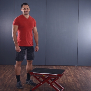 Smiling man standing at side on Intermediate Plyo Box Workout.