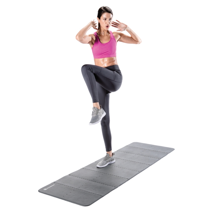 Standing woman lifting one leg and bending a knee