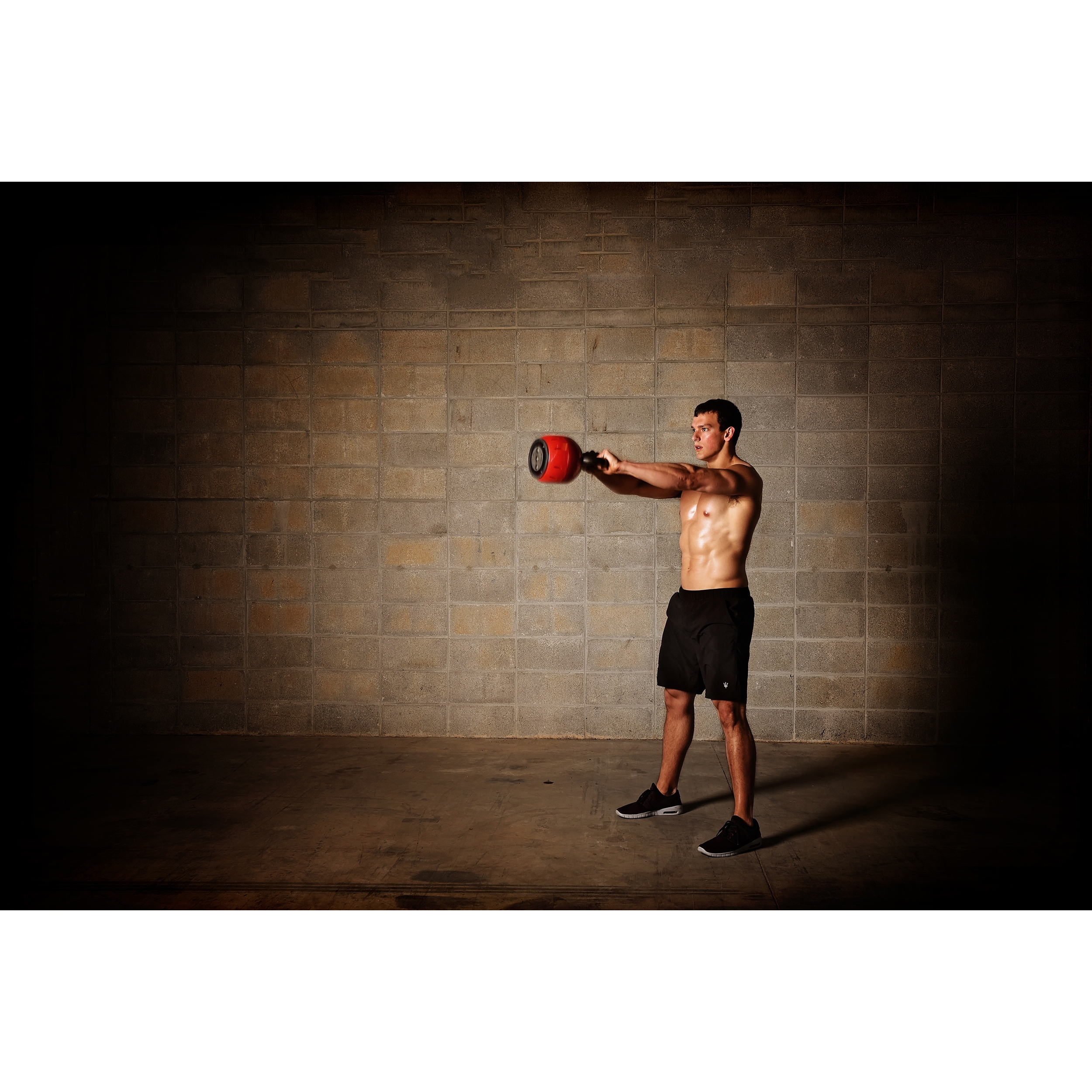 Man performing exercise on Stamina® 36 lb. Adjustable Kettle Versa-Bell.