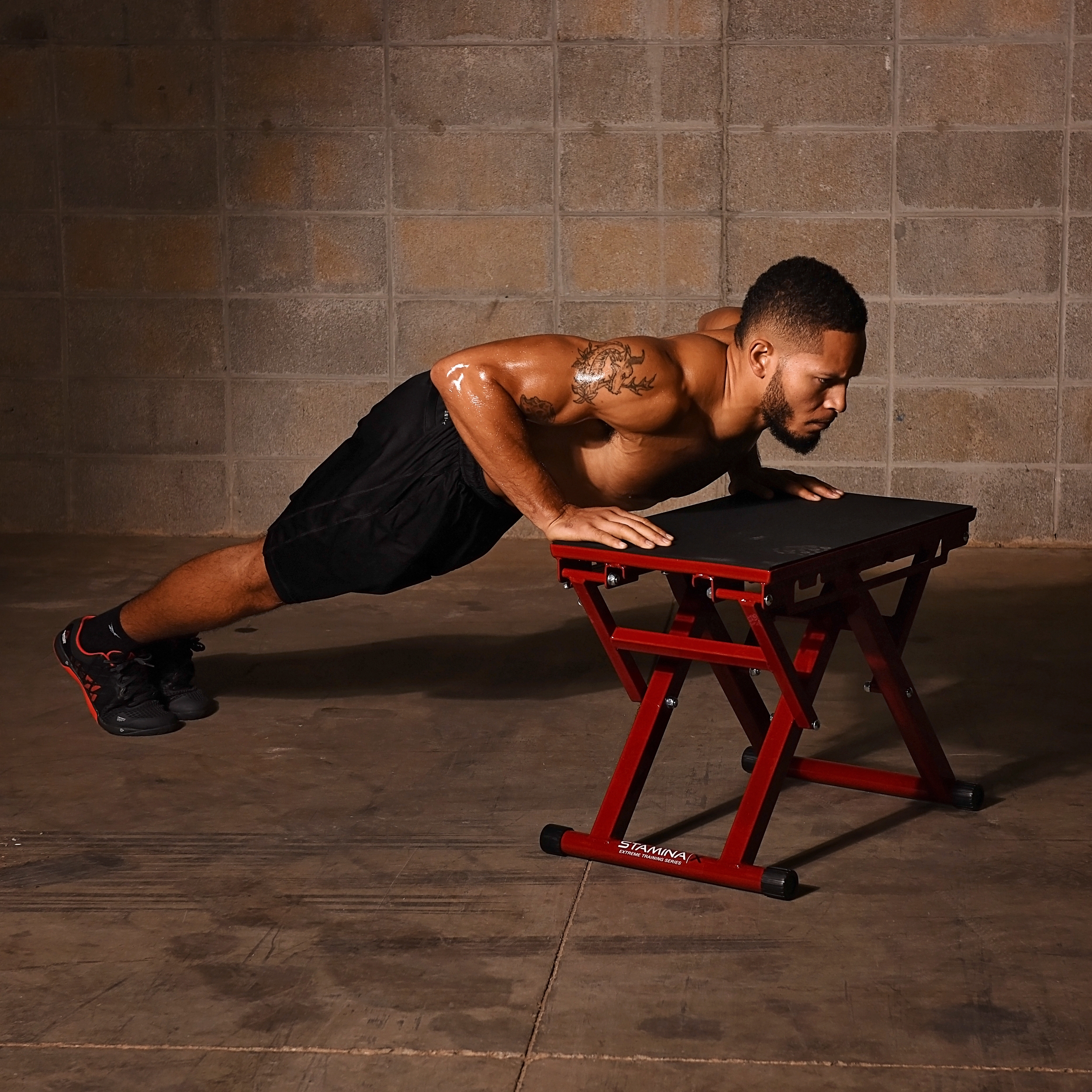 Man performing push-up on Stamina X Adjustable Height Plyo Box.