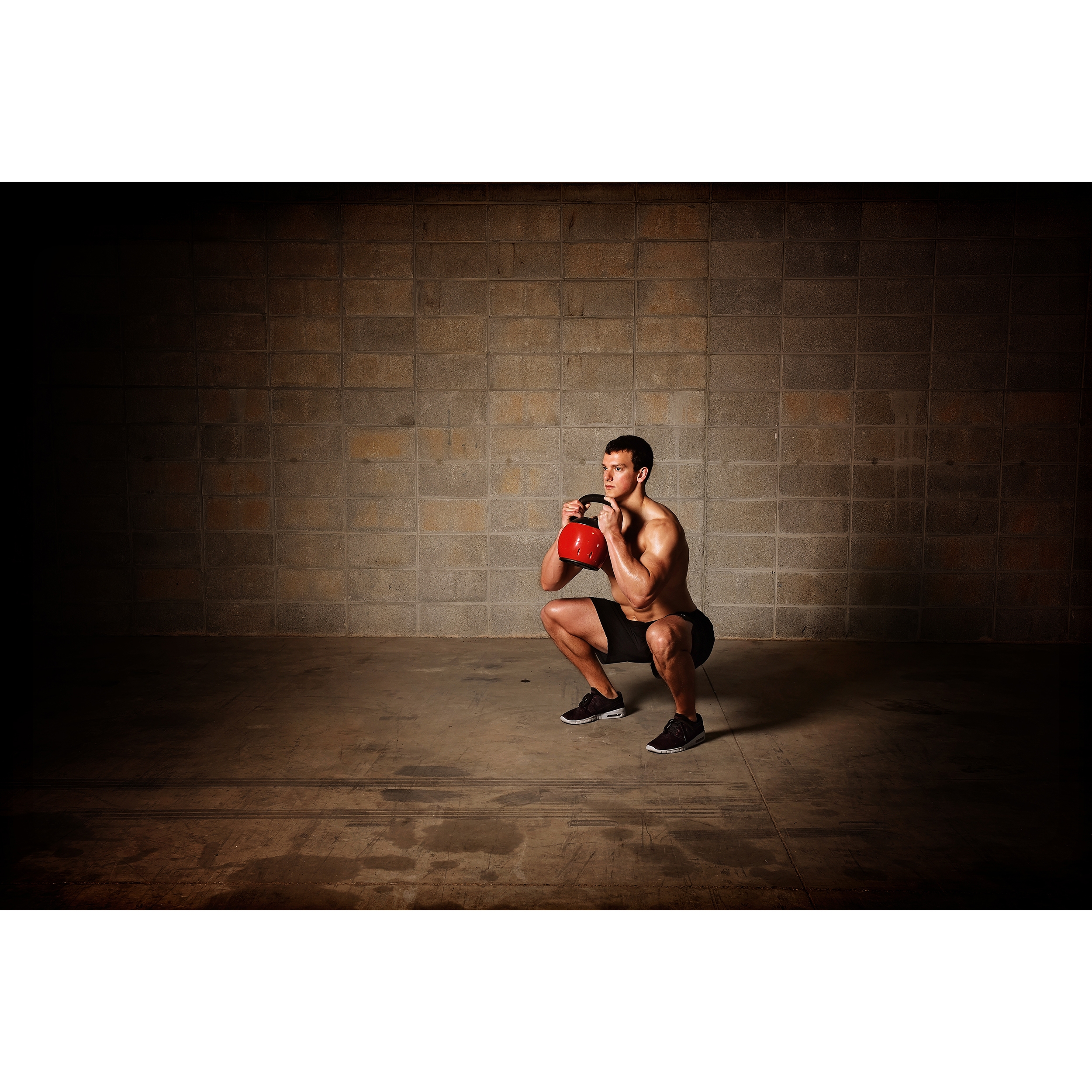 Man performing exercise on Stamina Kettle Versa-Bell.