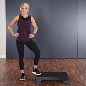 Woman stepping on Aerobic step.
