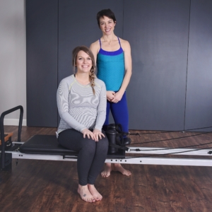 Pregnant woman seated on Prenatal Workout.