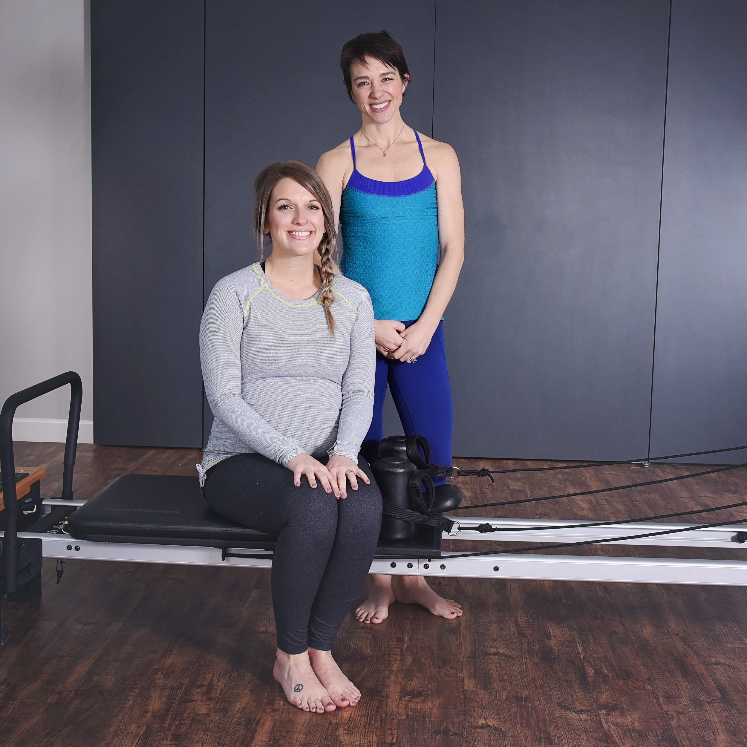 Pregnant woman seated on Prenatal Workout.