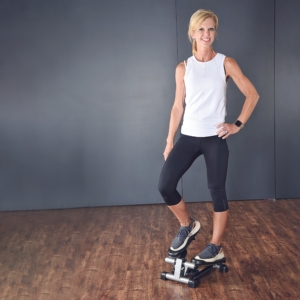 Woman stepping on Mini Stepper.