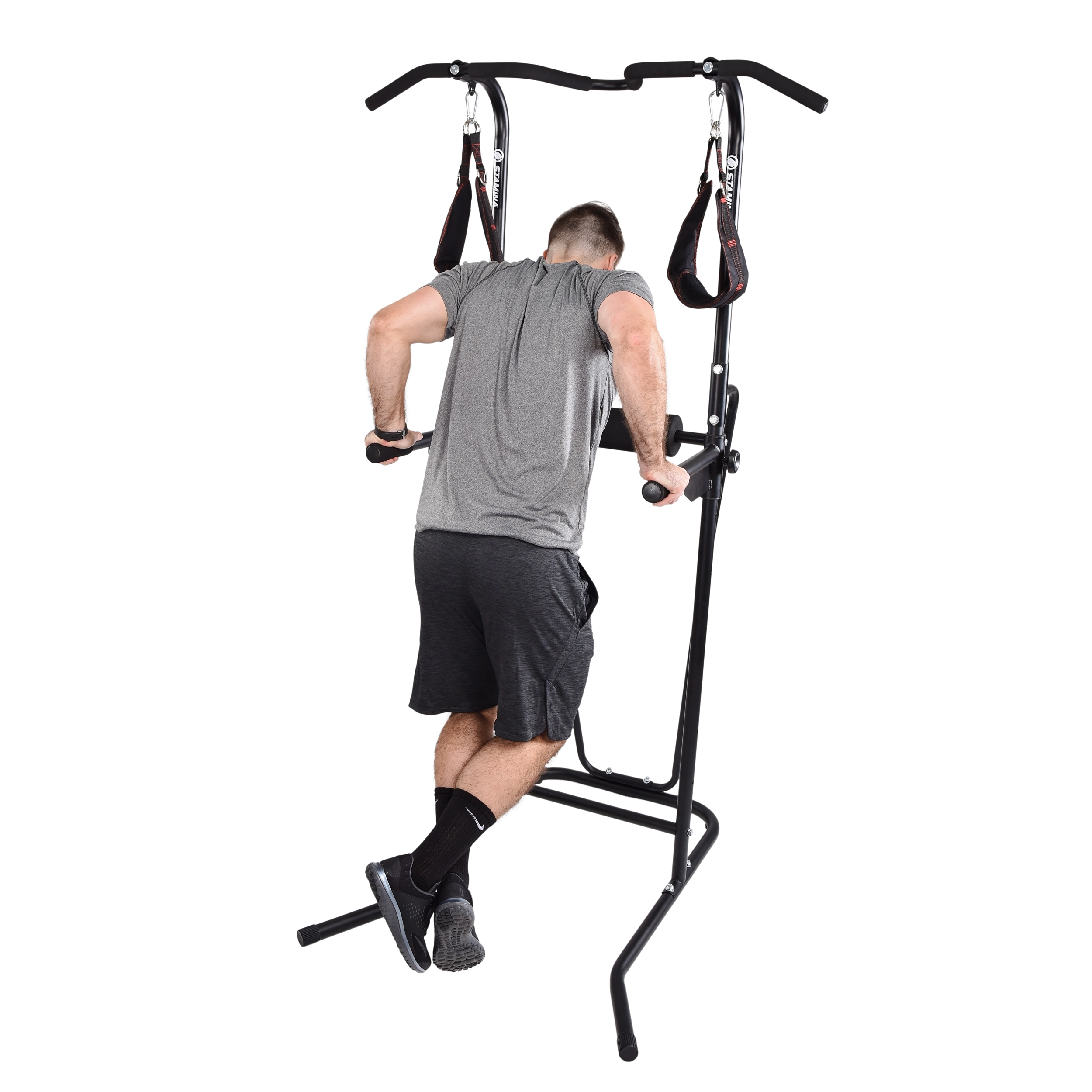 Man with arms nearly locked using the stamina power tower with bars at a middle extension.