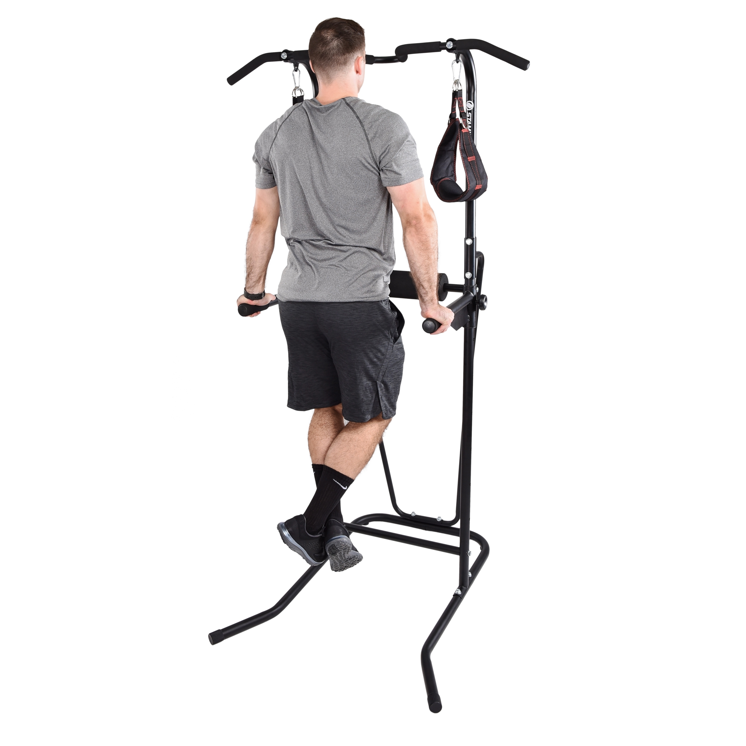 Man with arms nearly locked using the stamina power tower with bars at a higher extension.