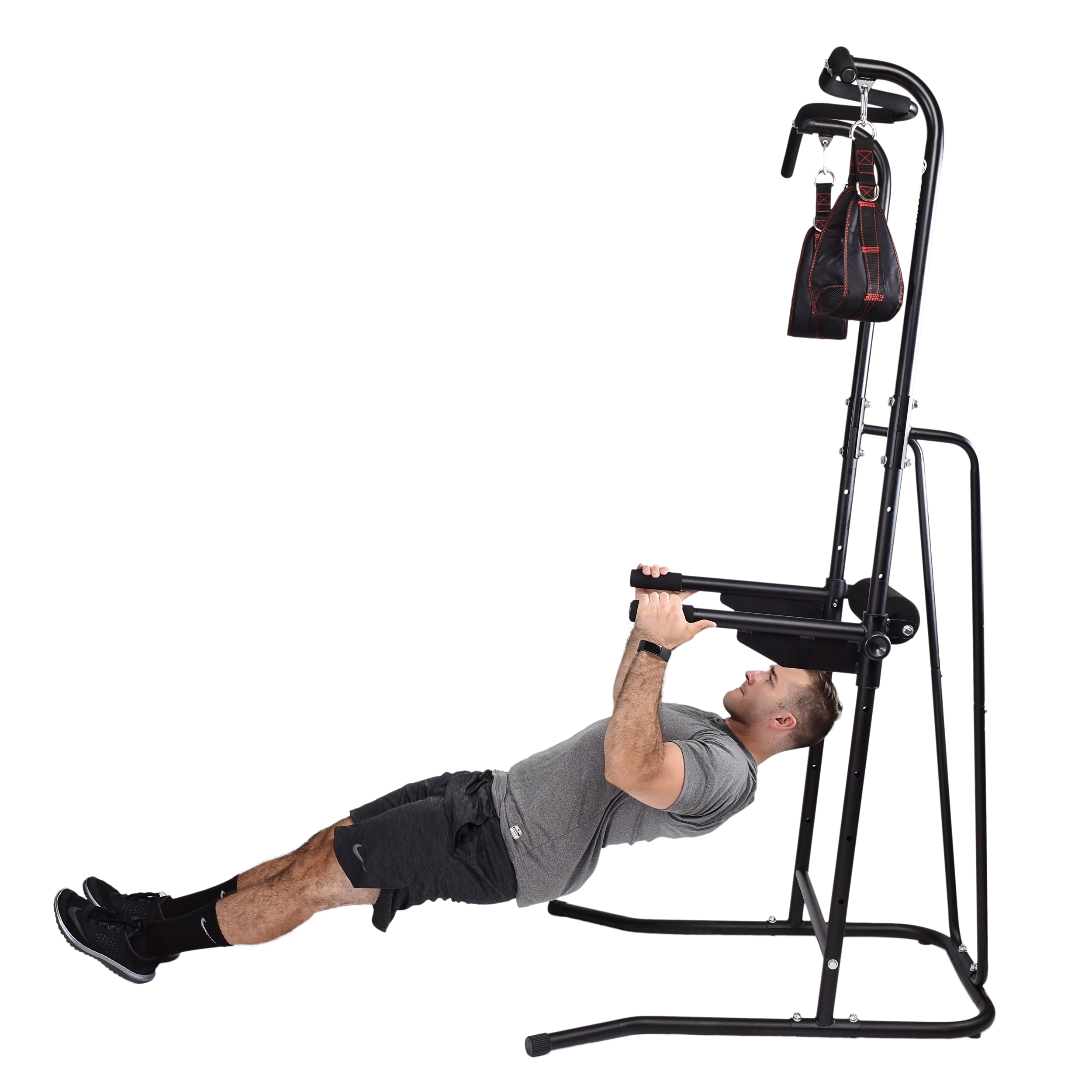 Side shot of man pulling himself up on power tower.