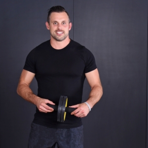 Middle age man holding the Ab-Wheel.