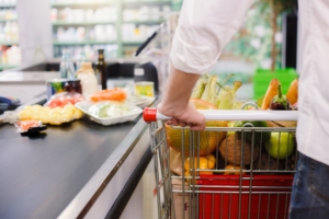 Man buying food products in the supermarket shopping