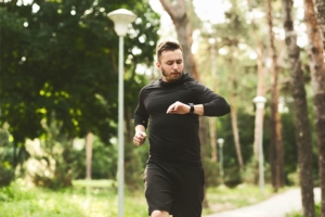Millennial man working out with fitness bracelet